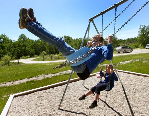 WAYNE GLOWACKI / WINNIPEG FREE PRESS

 Peonan Point School students Owen Olson,11, at left and his sister Morgan,14, on the swings outside their school. They only two students attending class  in the school on this day.     Bill Redekop story. June 9  2017