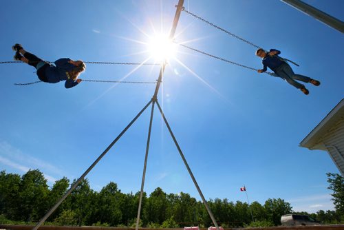 WAYNE GLOWACKI / WINNIPEG FREE PRESS

 Peonan Point School students Owen Olson,11, at right and his sister Morgan,14, on the swings outside their school. They only two students attending class in the school on this day.     Bill Redekop story. June 9  2017