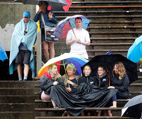 PHIL HOSSACK / WINNIPEG FREE PRESS  -  ONLY THE FAITHFUL - Parents and family wait and watch patiently under tarps and umbrellas Friday afternoon at the Provincial Track meet......even in the rain.    -  June 9, 2017