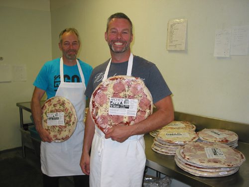 Canstar Community News May 31, 2017 - (From left) Ray and Phil Mollot, owners of Archie's Meats in Starbuck, show two of the ten pizza varieties they make. (ANDREA GEARY/CANSTAR COMMUNITY NEWS)