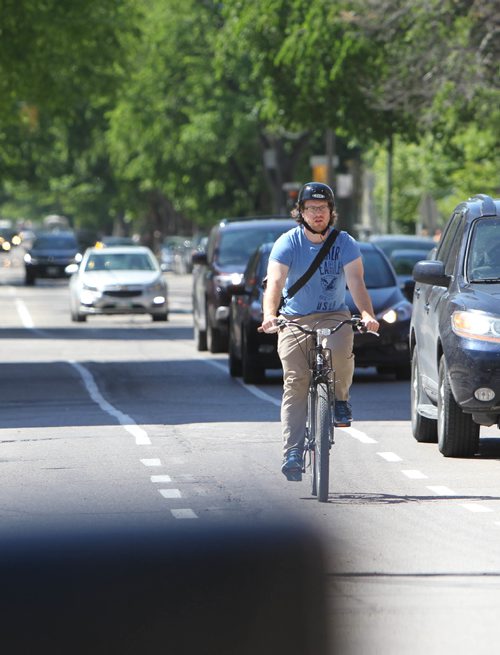 RUTH BONNEVILLE / WINNIPEG FREE PRESS

A cyclist makes their way down the bike path on McDermot Ave. Monday.  
See story on bike lanes.  

June 12, 2017