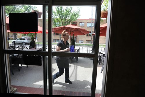 RUTH BONNEVILLE / WINNIPEG FREE PRESS

Christina Tennis, server at Colosseo restaurant on Corydon, heads to her tables on the patio Monday.  She comments on new smoking ban coming on patios. 

June 12, 2017