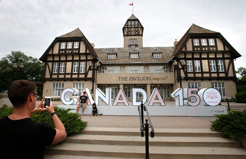 WAYNE GLOWACKI / WINNIPEG FREE PRESS

Denis Grenier takes a photo of Matthew Linklater and Rosco with the sign to celebrate Canadas 150th this year in front of the Pavilion in the Assiniboine Park. The Canada 150 3D public art installation is one of 19 signs that will be on display across Canada as part of the Sesquicentennial celebrations.¤
 For story. June 13   2017