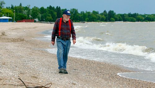 BORIS MINKEVICH / WINNIPEG FREE PRESS
Commercial fishermen Robert Kristjanson in Gimli. He's been commercial fishing in Gimli since he was 14 and he's now 83. His family has been in the commercial fishing business since the 1800's. He thinks the Zebra mussels are gonna eventually spell doomsday for the lake. Here he walks down the beach in Gimli. June 12, 2017
