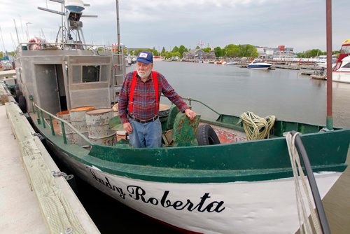 BORIS MINKEVICH / WINNIPEG FREE PRESS
Commercial fishermen Robert Kristjanson in Gimli. He's been commercial fishing in Gimli since he was 14 and he's now 83. His family has been in the commercial fishing business since the 1800's. He thinks the Zebra mussels are gonna eventually spell doomsday for the lake. Here he poses on his fishing boat docked at Gimli Harbour. June 12, 2017
