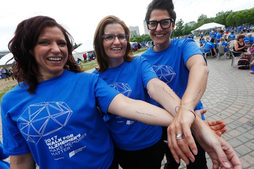 JOHN WOODS / WINNIPEG FREE PRESS
Terry Law's daughters Christy Law, Kerri Pleskach and Tara Liske show off their tattoos at the Walk For Alzheimers at the Forks Tuesday, June 13, 2017.