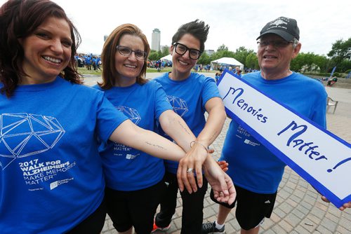 JOHN WOODS / WINNIPEG FREE PRESS
Terry Law is joined by his daughters, from left, Christy Law, Kerri Pleskach and Tara Liske, who are showing off their tattoos, at the Walk For Alzheimers at the Forks Tuesday, June 13, 2017.