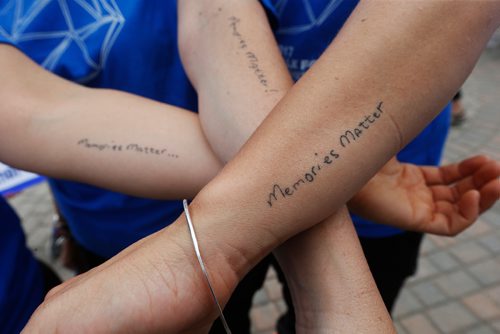 JOHN WOODS / WINNIPEG FREE PRESS
Terry Law's daughters Christy Law, Kerri Pleskach and Tara Liske show off their tattoos at the Alzheimers Walk at the Forks Tuesday, June 13, 2017.