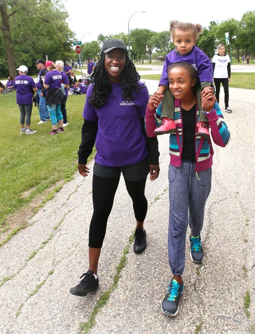 WAYNE GLOWACKI / WINNIPEG FREE PRESS

Debbie Yeboah, left and her cousins Sabea carrying her sister Nala after completing the  ALS Society of Manitobas 18th Annual Walk Saturday. Over 2200 people were expected to take part in the  5 km. walk in Assiniboine Park to raise money to support client services here in Manitoba and help fund research.  At the celebration after the walk it was announced the amount raised had reached $230,000. June 17   2017