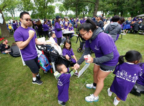 WAYNE GLOWACKI / WINNIPEG FREE PRESS

Kim and Philip Lacap and their family enjoy a snack after completing the  ALS Society of Manitobas 18th Annual Walk Saturday. Over 2200 people were expected to take part in the  5 km. walk in Assiniboine Park to raise money to support client services here in Manitoba and help fund research.  At the celebration after the walk it was announced the amount raised had reached $230,000. June 17   2017