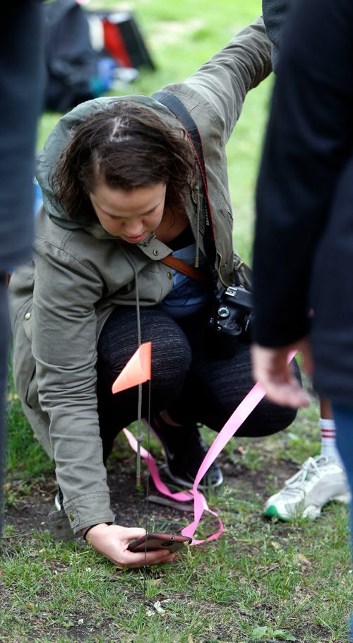WAYNE GLOWACKI / WINNIPEG FREE PRESS

 Drag the Red volunteers took a forensic training workshop at the University of Winnipeg Saturday then did some field work in Central Park. Melissa Hansen takes a photo of a bone found found. Organizers had placed bone fragments in the grass for participants to take part in an organized search and to properly record  findings. Melissa Martin story  June 17   2017