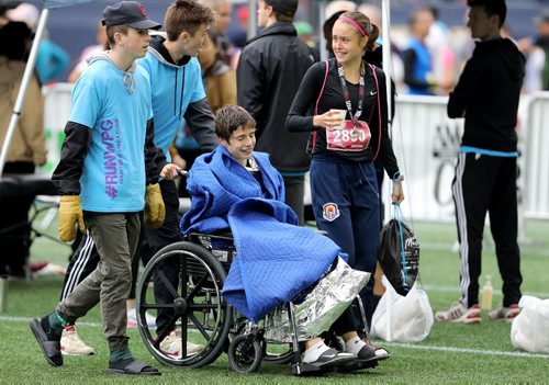 TREVOR HAGAN / WINNIPEG FREE PRESS
Half Marathon, mens winner, Daniel Heschuk, receives medical attention following the 39th Manitoba Marathon, Sunday, June 18, 2017.