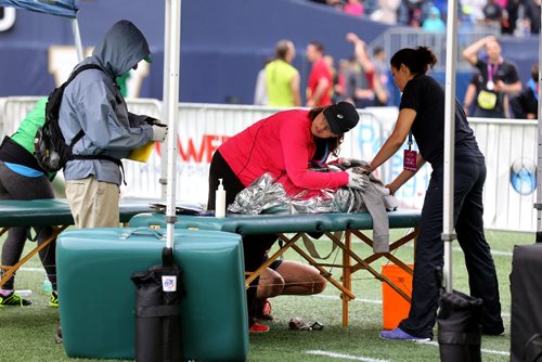 TREVOR HAGAN / WINNIPEG FREE PRESS
Half Marathon, mens winner, Daniel Heschuk, receives medical attention following the 39th Manitoba Marathon, Sunday, June 18, 2017.