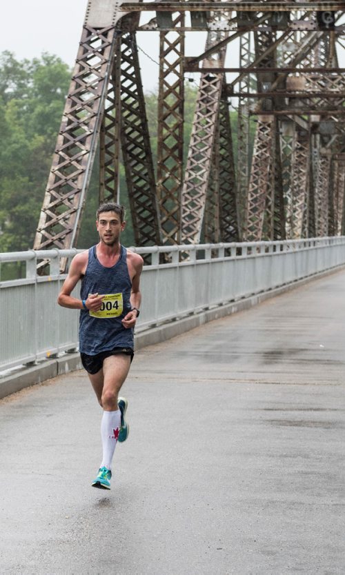 DAVID LIPNOWSKI / WINNIPEG FREE PRESS

Half Marathon participants run over the Elm Park Bridge Sunday June 18, 2017.