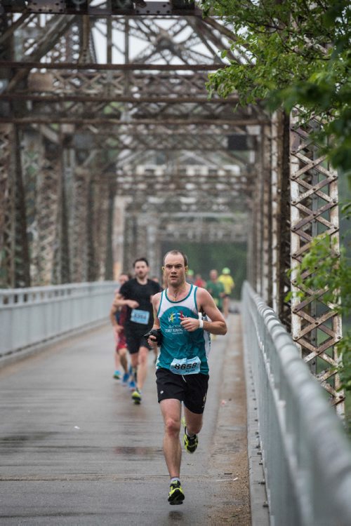 DAVID LIPNOWSKI / WINNIPEG FREE PRESS

Half Marathon participants run over the Elm Park Bridge Sunday June 18, 2017. William Wellborn is the runner pictured here.