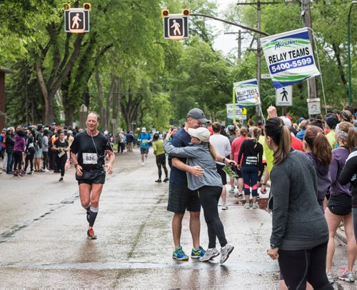 DAVID LIPNOWSKI / WINNIPEG FREE PRESS

Manitoba Marathon relay participants Miles Macdonell gets a hug from National Leasing coworker Alfie Imbrogno as they hand off during their run on Wolseley Avenue Sunday June 18, 2017 in a relay exchange zone.