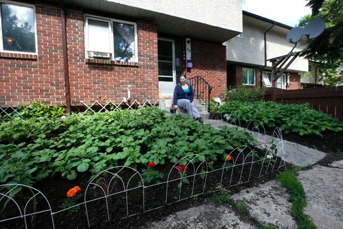 WAYNE GLOWACKI / WINNIPEG FREE PRESS

Korrina Hargreaves with her front yard garden of vegetables, herbs and flowers at her Manitoba Housing unit at 1380 Raleigh St. She and another friend at the property faced the prospect of having their flowers, herbs and vegetables ripped out because of a agency policy that prohibits planting anything but grass in front yards. Gord Sinclair story  June 19   2017