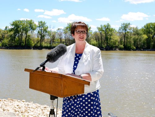 JUSTIN SAMANSKI-LANGILLE / WINNIPEG FREE PRESS
Eileen Clarke, Minister of Indigenous and Municipal Relations speaks at a press conference and ribbon cutting ceremony on the shore of the Red River Monday. The ceremony officially opened a new section of multi-use trials connecting Point Douglas to The Forks.
170619 - Monday, June 19, 2017.