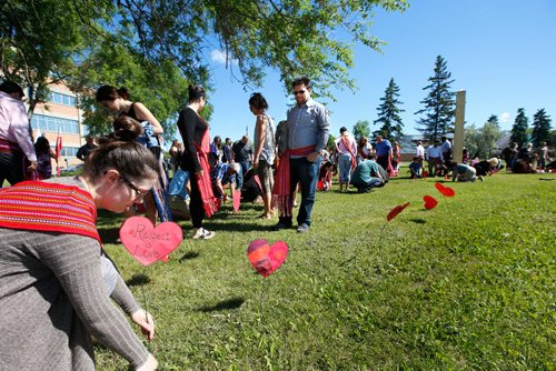 WAYNE GLOWACKI / WINNIPEG FREE PRESS

About 100 attended the Metis Red Heart Ceremony Tuesday to recognize Metis Residential and Day School Survivors.  The ceremony was held beside the MMF building included placing paper hearts in the ground with messages to honour and recognize residential and day school survivors.¤The event also included planting an apple tree in front of MMF building that will one day provide fruit for members of the community.  June 20   2017