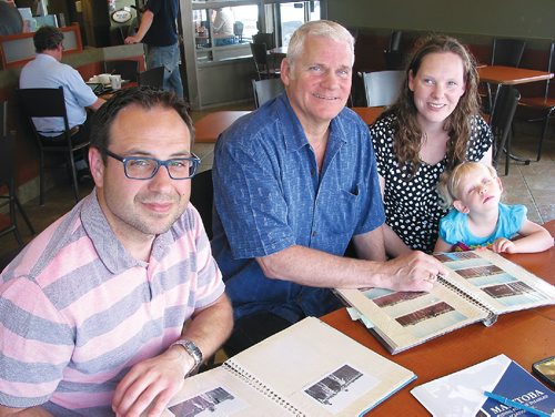 Canstar Community News June 6, 2017 - (From left) Manitoba Riding for the Disabled executive director Peter Manastrysky, instructor Graham Curnew, board chair Darraugh Sichewski and her daughter Lillian look at photos taken over the organization's past 40 years. (ANDREA GEARY/CANSTAR COMMUNITY NEWS)