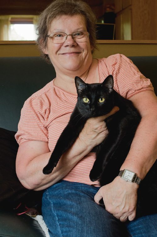 Canstar Community News June 13, 2017 - Joy Leschasin poses with her cat Southendz Ebony Lass in her Whyte Ridge home. Leschasin is the show manager of the International Cat Show, hosted by the Manitoba Cat Club, on July 1 and 2. (DANIELLE DA SILVA/SOUWESTER/CANSTAR)