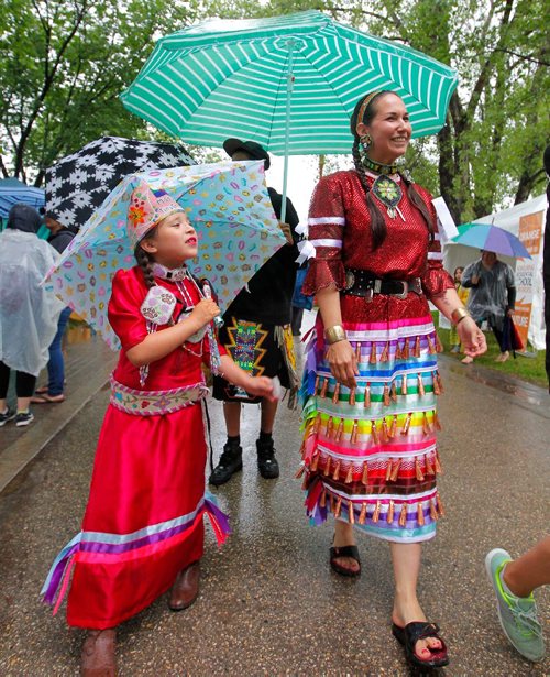 BORIS MINKEVICH / WINNIPEG FREE PRESS
APTN Aboriginal Day live at The Forks. From left, dancers Mason Bear,7, of Peguis First Nation and Micheline Berard of Portage la Prairie tour the Forks site where the event is taking place. June 21, 2017
