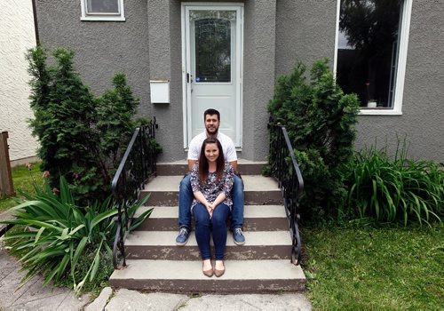 PHIL HOSSACK / WINNIPEG FREE PRESS  - New millennial home owners  Cait and Shawn Dyck pose at their Woseley home purchased with help from family. See Joel Schlessinger's story. June 22, 2017