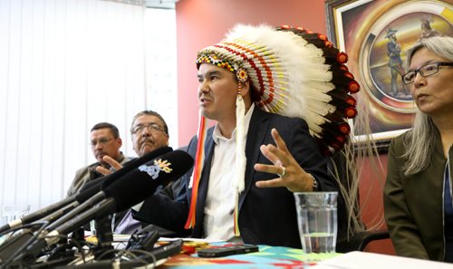 RUTH BONNEVILLE / WINNIPEG FREE PRESS

Keewatin Tribal Council Chiefs hold press conference asking for the  government to take immediate action on repairing the rail line to churchill at MKO office (Manitoba Keewatinowi Okimakanak) in Winnipeg Friday.

Chief Ted Bland of the York Factory First Nation (centre wt feathers) answers questions from the media during press conference.  Names of people at the table L - R:  Robert Spence Councillor with Tataskweyak - Keewatin Tribal First Nation, Clarence Easter Chemawawin Cree nation Chief, Chief Ted Bland of the York Factory First Nation (feathers), Chief Betsy Kennedy War Lake First Nation and Michael Spence Mayor of Churchill (not in this photo but also at the table).  

See story.  
June 23, 2017