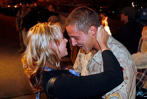 BORIS MINKEVICH / WINNIPEG FREE PRESS  080904 Cpl. Jean-Pierre Gosselin embraces his girlfriend Rebecca Arnold after returning from Afghanistan. They came to Minto Armouries in Winnipeg.