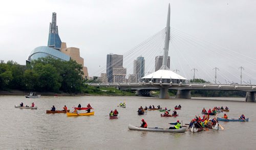 BORIS MINKEVICH / WINNIPEG FREE PRESS
Rendez-Vous on the Red - In celebration of the150th anniversary of Canada, voyageurs of La Brigade de la Rivière Rouge, also celebrating its 40th anniversary, recreated the historic paddle along the Red River from St. Jean-Baptiste to The Forks. Many Canoes on the Rouge on the Red River in front of St. Boniface Cathedral. June 24, 2017
