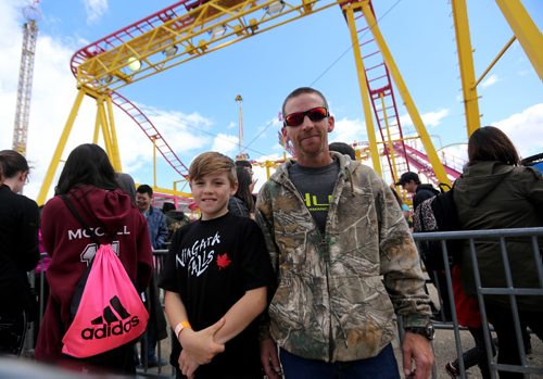TREVOR HAGAN / WINNIPEG FREE PRESS
Randy Lagimodiere, right, and his son, Jordan, 11, After poor weather over the last couple weeks, many people took the opportunity to visit the Red River Ex, Sunday, June 25, 2017.