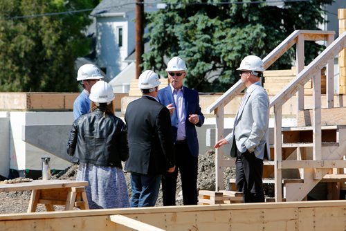 JUSTIN SAMANSKI-LANGILLE / WINNIPEG FREE PRESS
Habitat For Humanity Manitoba CEO Sandy Hopkins (Centre Right) guides a tour of the Habitat build site in the 200 block of Lyle Street following a press event announcing a combined investment of $1.2 million from the provincial and federal governments into affordable housing for Manitobans.
170626 - Monday, June 26, 2017.