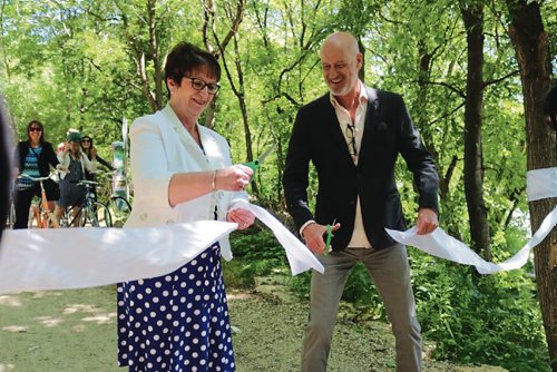 Canstar Community News June 20, 2017 - Minister of Indigenous and municipal relations Eileen Clarke and The Forks North Portage CEO Paul Jordan cut the ribbon at the new waterfront pathway opening. (LIGIA BRAIDOTTI/CANSTAR COMMUNITY NEWS/TIMES)