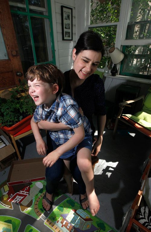 PHIL HOSSACK / WINNIPEG FREE PRESS  -    Rebecca Chambers and her four-year-old son Henry .. (diagnosed with autism last year) pose in their home Monday.
Henry is one of the unknown number of preschool children living with special needs that was going to be denied entry into daycare because of the provinces hold on funding for aides.
But suddenly on Sunday they received calls from the province and the day care to say that suddenly they had funding for an aide.
-  June 26, 2017