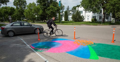 MIKE DEAL / WINNIPEG FREE PRESS
Pedestrians cross the road at Aulneau Street and de la Cathédrale Avenue where a local art project called Cool Streets has been installed. The project had local artists paint designs at various intersections and crosswalks at eight sites.
170627 - Tuesday, June 27, 2017.