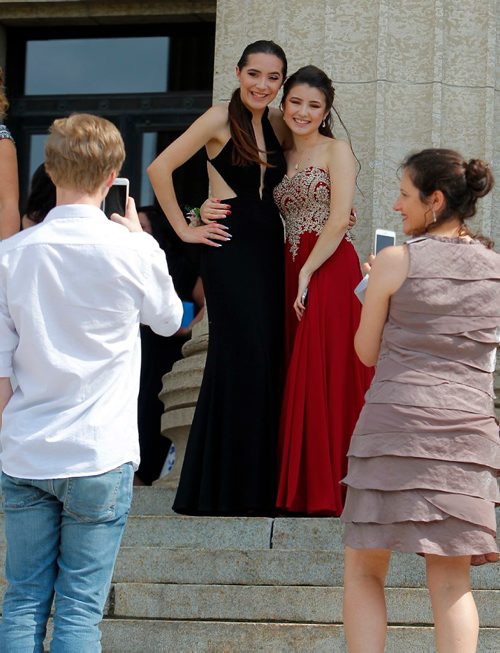 BORIS MINKEVICH / WINNIPEG FREE PRESS
Some parents take some photos of High school grads (from left) Brooklyn Rzepczynski, Garden City Collegiate and Lara Takahashi, of MBCI on the steps of the Manitoba Legislature Tues. afternoon. There are from different schools but are good friends. June 27, 2017

