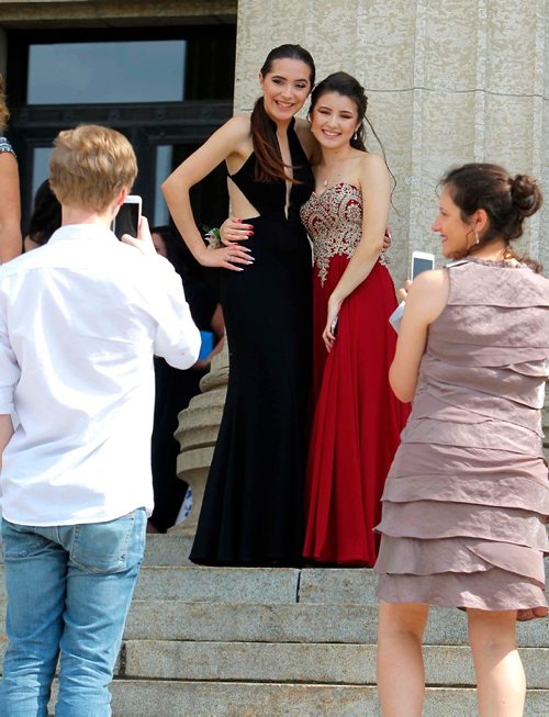 BORIS MINKEVICH / WINNIPEG FREE PRESS
Some parents take some photos of High school grads (from left) Brooklyn Rzepczynski, Garden City Collegiate and Lara Takahashi, of MBCI on the steps of the Manitoba Legislature Tues. afternoon. There are from different schools but are good friends. June 27, 2017
