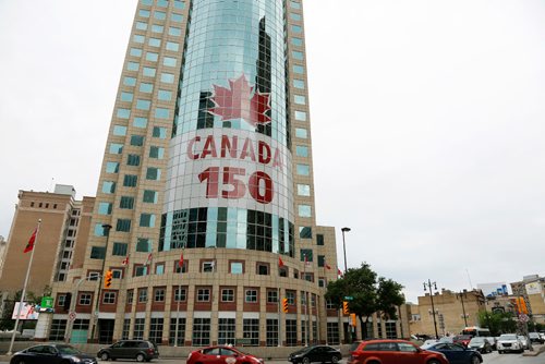 JUSTIN SAMANSKI-LANGILLE / WINNIPEG FREE PRESS
Harvard Developments unveiled a new 14 story tall mural celebrating Canada's 150th Wednesday. The mural is on the face of 201 Portage and is 5,000 squared feet in surface area.
170628 - Wednesday, June 28, 2017.
