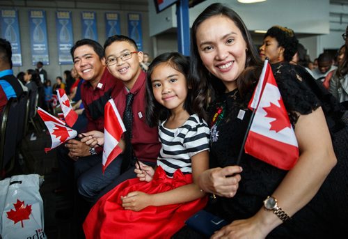 MIKE DEAL / WINNIPEG FREE PRESS
Rowena Hidalgo and her husband Manollete with kids (from left) Xander, 12, and Xanthea, 7, were among the 93 new citizens at a special citizenship ceremony in celebration of Canada's 150th birthday, at the Investors Group Field.
170628 - Wednesday, June 28, 2017.