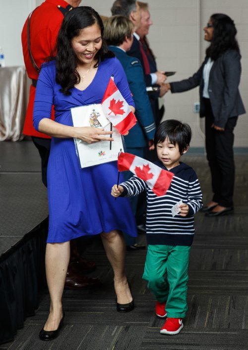 MIKE DEAL / WINNIPEG FREE PRESS
Emil Jaen Marquez and her son Philip, 3, were among the 93 new citizens at a special citizenship ceremony in celebration of Canada's 150th birthday, at the Investors Group Field.
170628 - Wednesday, June 28, 2017.