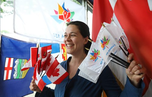 RUTH BONNEVILLE / WINNIPEG FREE PRESS


The Flag Shop manager and member of the family which owns the store Samantha Hobson waves bundles of  Canada 150 flags and Canada flags in her store just a few days before Canada's 150th birthday.

See story on how poll states we are more patriotic now than we were a decade ago.  
Kevin Rollason's story.  
June 28, 2017