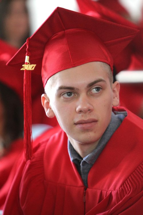 RUTH BONNEVILLE / WINNIPEG FREE PRESS

49.8 Feature: Class of  2017 Project:    
Avery with his red cap and gown on at convocation ceremony.  

Final photos of The class of 2017 students (15),  on their graduation day from Glenlawn Collegiate.  Their convocation ceremony was held at The RBC Convention Centre on June 26th 2017 as well as their dinner and dance later that evening.  
See story on WFP's 13 year documentary on a group of students  who the Free Press followed and photographed from their 1st year in kindergarden in Windsor School to their graduating year in 2017 at Glenlawn Collegiate. 

See Doug Speirs story.  

June 26, 2017