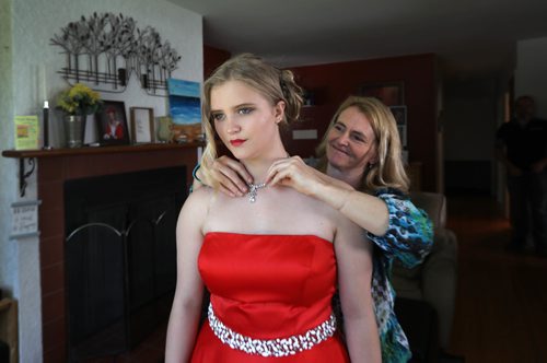 RUTH BONNEVILLE / WINNIPEG FREE PRESS

49.8 Feature: Class of  2017 Project:    Naomi's mom, Lori,  puts a necklace from Naomi's grandmother on her  at home before attending the graduation dinner.  

Final photos of The class of 2017 students (15),  on their graduation day from Glenlawn Collegiate.  Their convocation ceremony was held at The RBC Convention Centre on June 26th 2017 as well as their dinner and dance later that evening.  
See story on WFP's 13 year documentary on a group of students  who the Free Press followed and photographed from their 1st year in kindergarden in Windsor School to their graduating year in 2017 at Glenlawn Collegiate. 

See Doug Speirs story.  

June 26, 2017