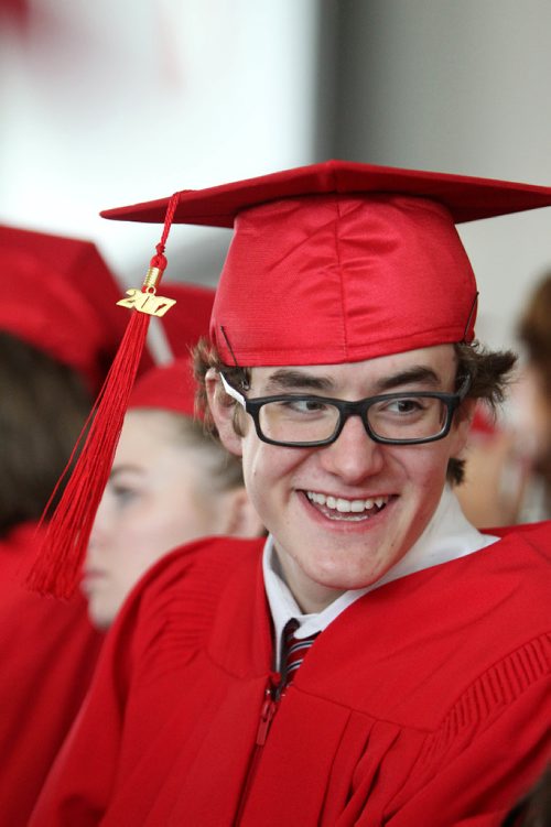 RUTH BONNEVILLE / WINNIPEG FREE PRESS

49.8 Feature: Class of  2017 Project:    
Noah is all smiles  with his red cap and gown on at convocation ceremony.  

Final photos of The class of 2017 students (15),  on their graduation day from Glenlawn Collegiate.  Their convocation ceremony was held at The RBC Convention Centre on June 26th 2017 as well as their dinner and dance later that evening.  
See story on WFP's 13 year documentary on a group of students  who the Free Press followed and photographed from their 1st year in kindergarden in Windsor School to their graduating year in 2017 at Glenlawn Collegiate. 

See Doug Speirs story.  

June 26, 2017