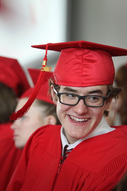 RUTH BONNEVILLE / WINNIPEG FREE PRESS

49.8 Feature: Class of  2017 Project:   
Noah is all smiles  with his red cap and gown on at convocation ceremony.   

Final photos of The class of 2017 students (15),  on their graduation day from Glenlawn Collegiate.  Their convocation ceremony was held at The RBC Convention Centre on June 26th 2017 as well as their dinner and dance later that evening.  
See story on WFP's 13 year documentary on a group of students  who the Free Press followed and photographed from their 1st year in kindergarden in Windsor School to their graduating year in 2017 at Glenlawn Collegiate. 

See Doug Speirs story.  

June 26, 2017