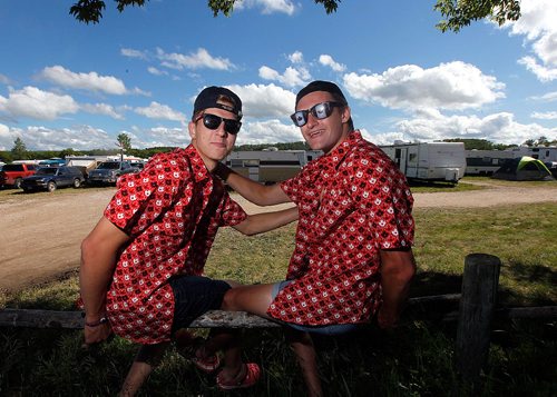 PHIL HOSSACK / WINNIPEG FREE PRESS  -  Festival goers and the temperature both heated up as the sun came oput Friday afternon at Dauphin's Country Festival. Nate Hooper (left) and Ryan Sokoloski made the trek from Winnipeg to sport their Canada Day shirts and more.. Keith Urban takes the stage at ten tonight.   -  June 30 2017