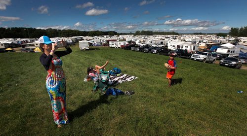 PHIL HOSSACK / WINNIPEG FREE PRESS  -  Festival goers and the temperature both heated up as the sun came oput Friday afternon at Dauphin's Country Festival. Christina Rose gets a panoramic shot of the "aluminum" village surrounding a smal knoll near the main stage with her daughter Elizabeth 11, and son Kaleb 6. The family's making a cross Canada road trip this summer and planned the Country Fest stop well in advance.  Keith Urban takes the stage at ten tonight.   -  June 30 2017