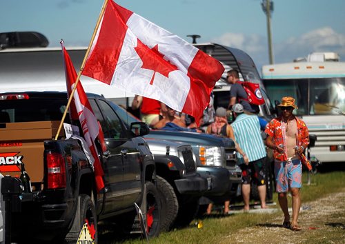 PHIL HOSSACK / WINNIPEG FREE PRESS  -  Festival goers and the temperature both heated up as the sun came oput Friday afternon at Dauphin's Country Festival. Country fans flew the flag proudly around the camper village. Keith Urban takes the stage at ten tonight.   -  June 30 2017