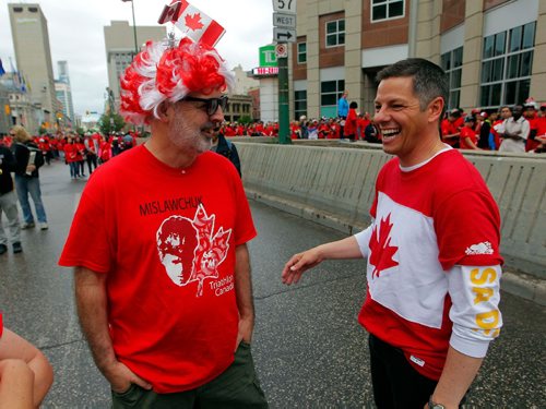 BORIS MINKEVICH / WINNIPEG FREE PRESS
3,600 proud Winnipeggers joined together bright and early at Portage & Main to create a human flag celebrating Canada Day. From left, Gil Tetreault meets Mayor Brian Bowman at the event. July 1, 2017
