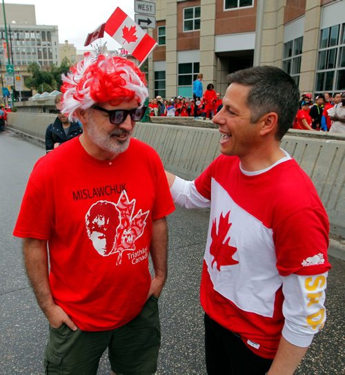 BORIS MINKEVICH / WINNIPEG FREE PRESS
3,600 proud Winnipeggers joined together bright and early at Portage & Main to create a human flag celebrating Canada Day. From left, Gil Tetreault meets Mayor Brian Bowman at the event. July 1, 2017
